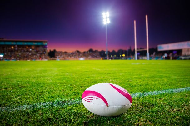 Floodlit rugby pitch at night