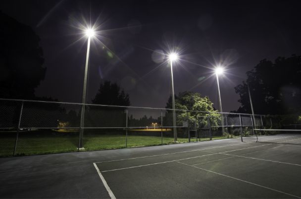Floodlit tennis court at night